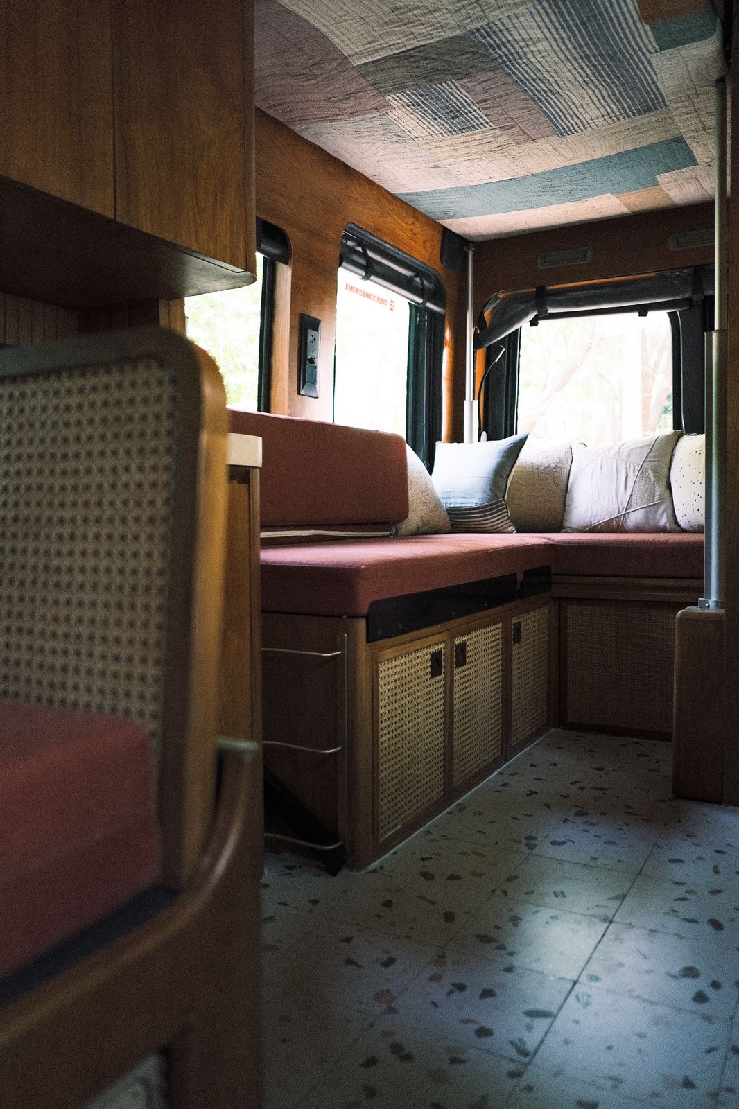 Interior of the Hobbit campervan with cane and natural wood finishes, built for a Delhi-based musician