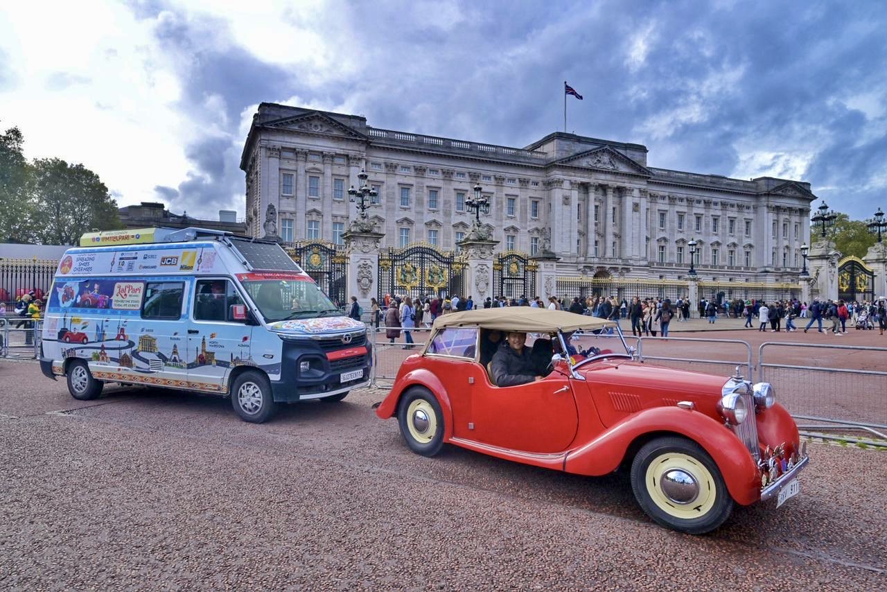 Lalpari Ki Saheli expedition van and vintage escort car outside Buckingham Palace, London, at the end of a 12,000km journey