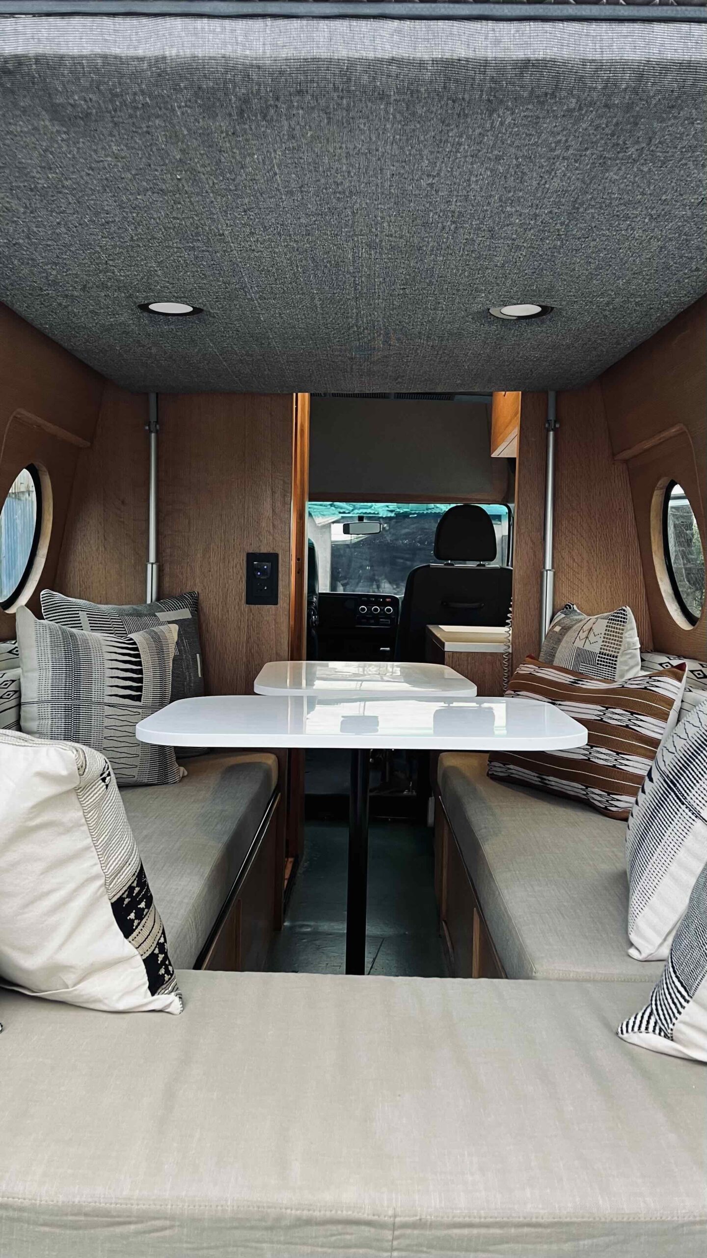 Interior of the Poly campervan set up as a mobile design studio with fold-out work tables